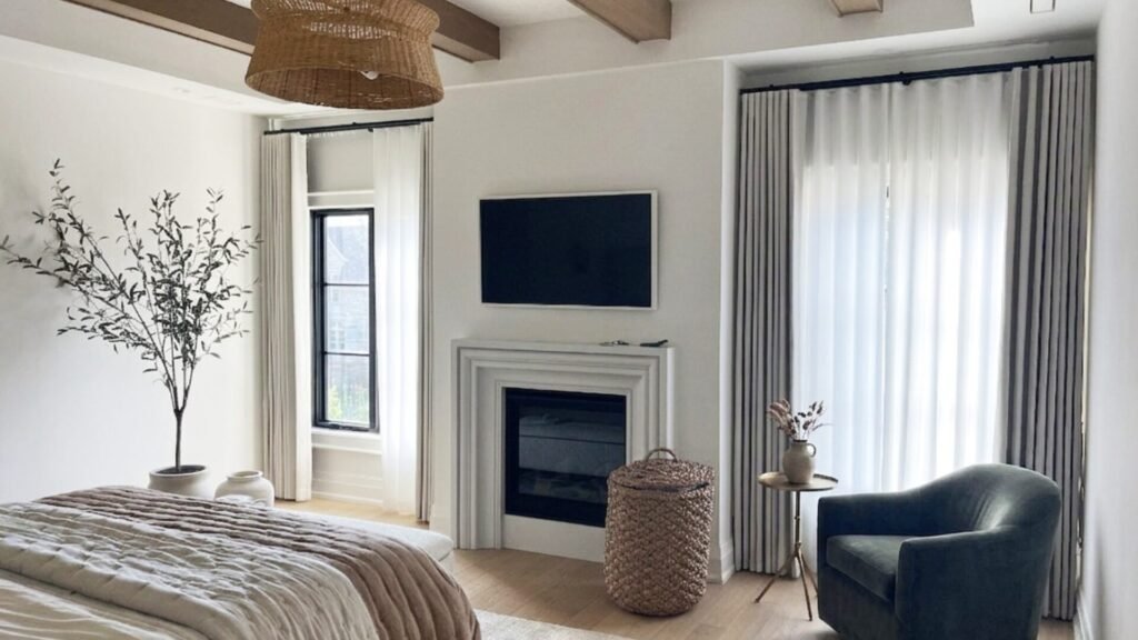 Modern Toronto house bedroom featuring floor-to-ceiling sheer drapes and natural colored curtains.