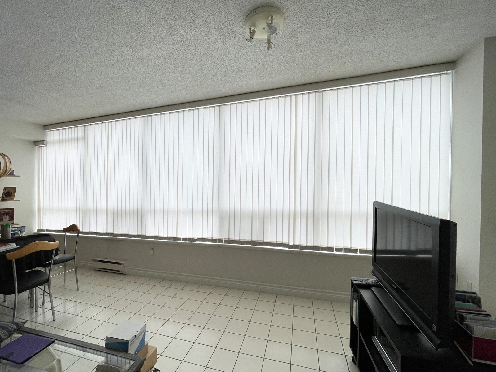 Vertical blinds installed on a wide window in a Toronto home