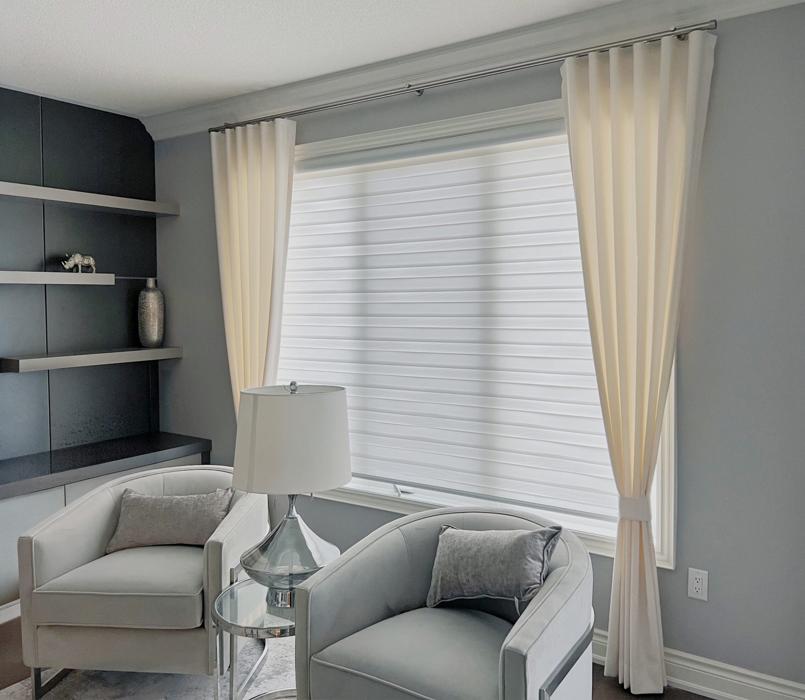 White zebra blinds layered with sheer drapery in a Toronto living room