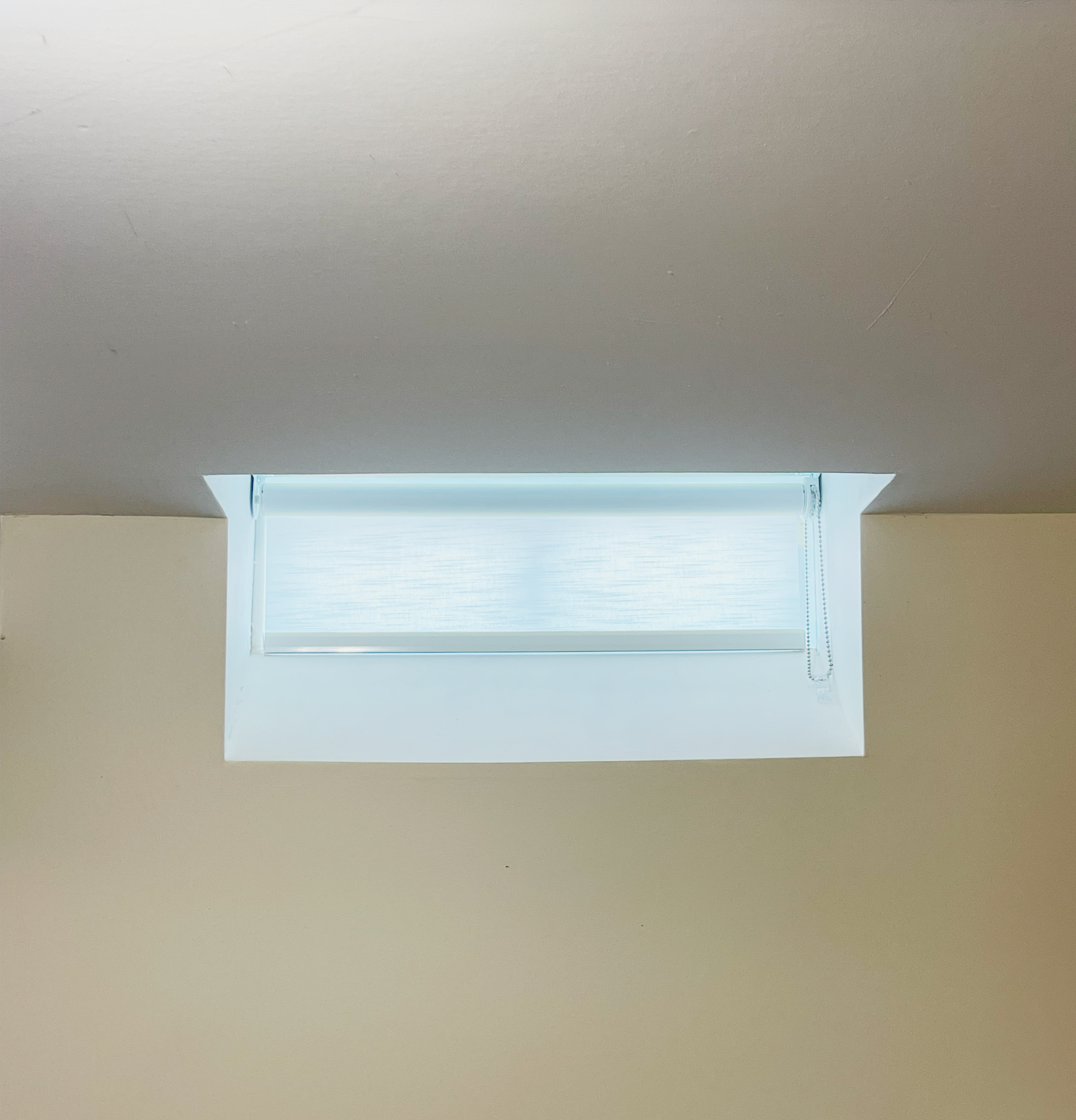 Finished basement in Etobicoke with properly treated hopper windows — inside-mount cellular shades flush within the frame, Starlight Shutter Toronto