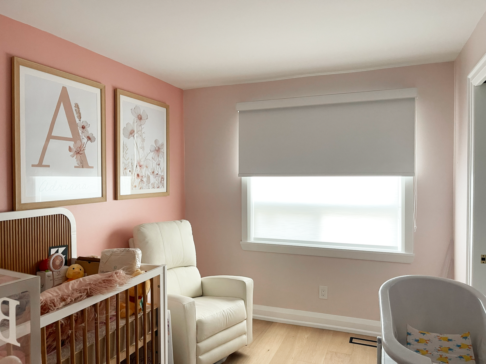 Dual-layered roller blinds, grey blackout over white light-filtering, in an Etobicoke nursery