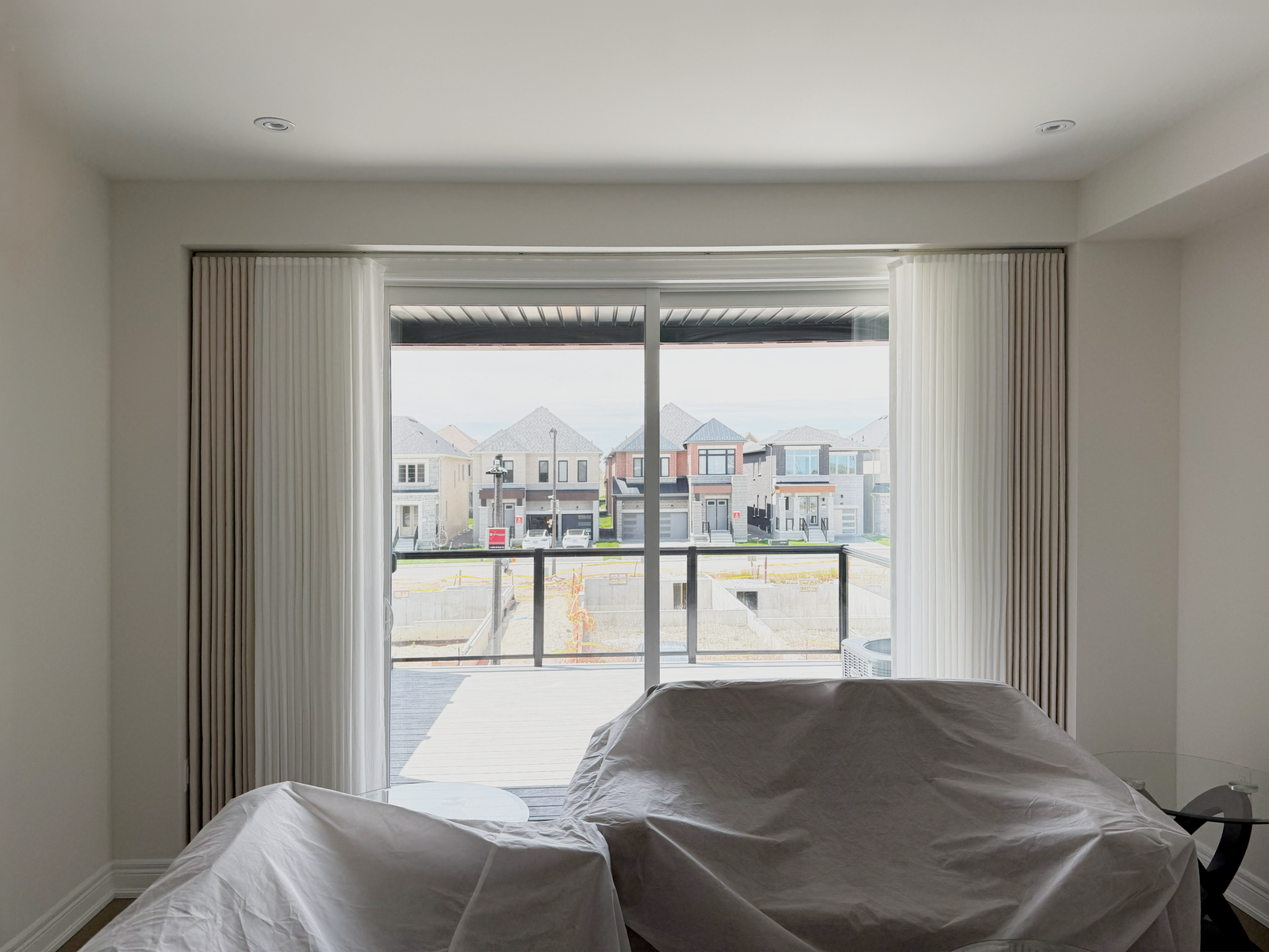 Sheer drapery on a living-room balcony door in a Markham home