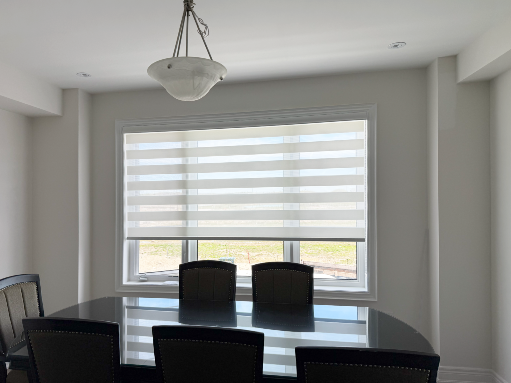 Wide horizontal zebra blinds offering privacy and light-filtering functionality in a contemporary dining room.