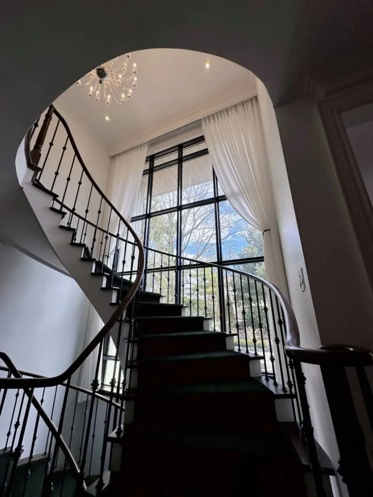 6ft high window with off white sheer drapery in a grand toronto house