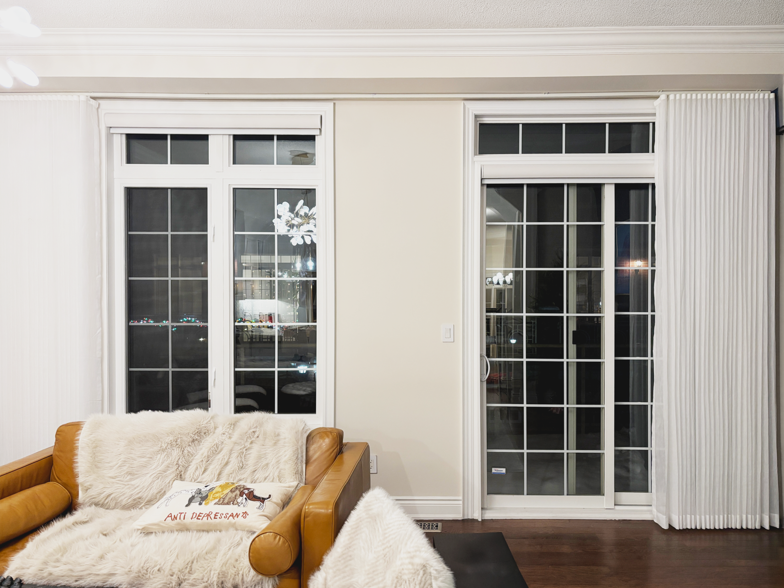 Sheer drapery panels framing French doors and windows in a Toronto living room