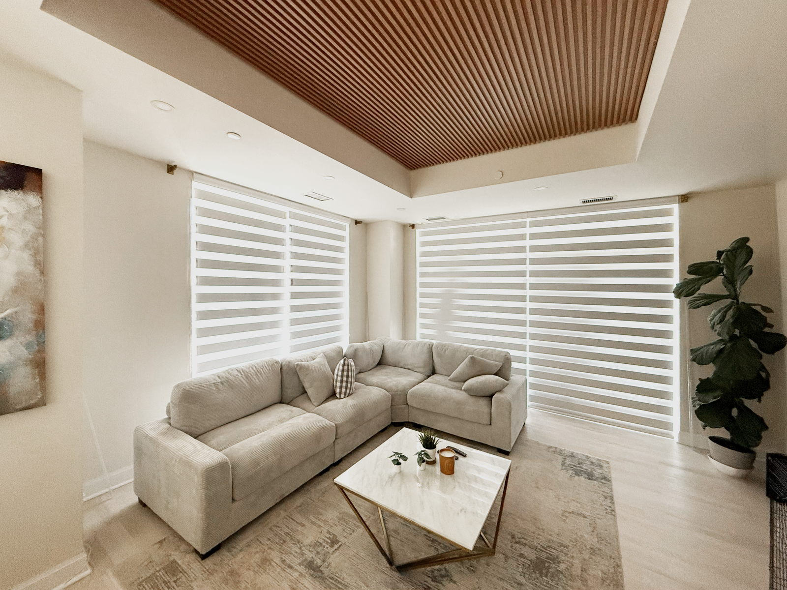 Zebra day-night blinds across large corner windows in a Toronto living room