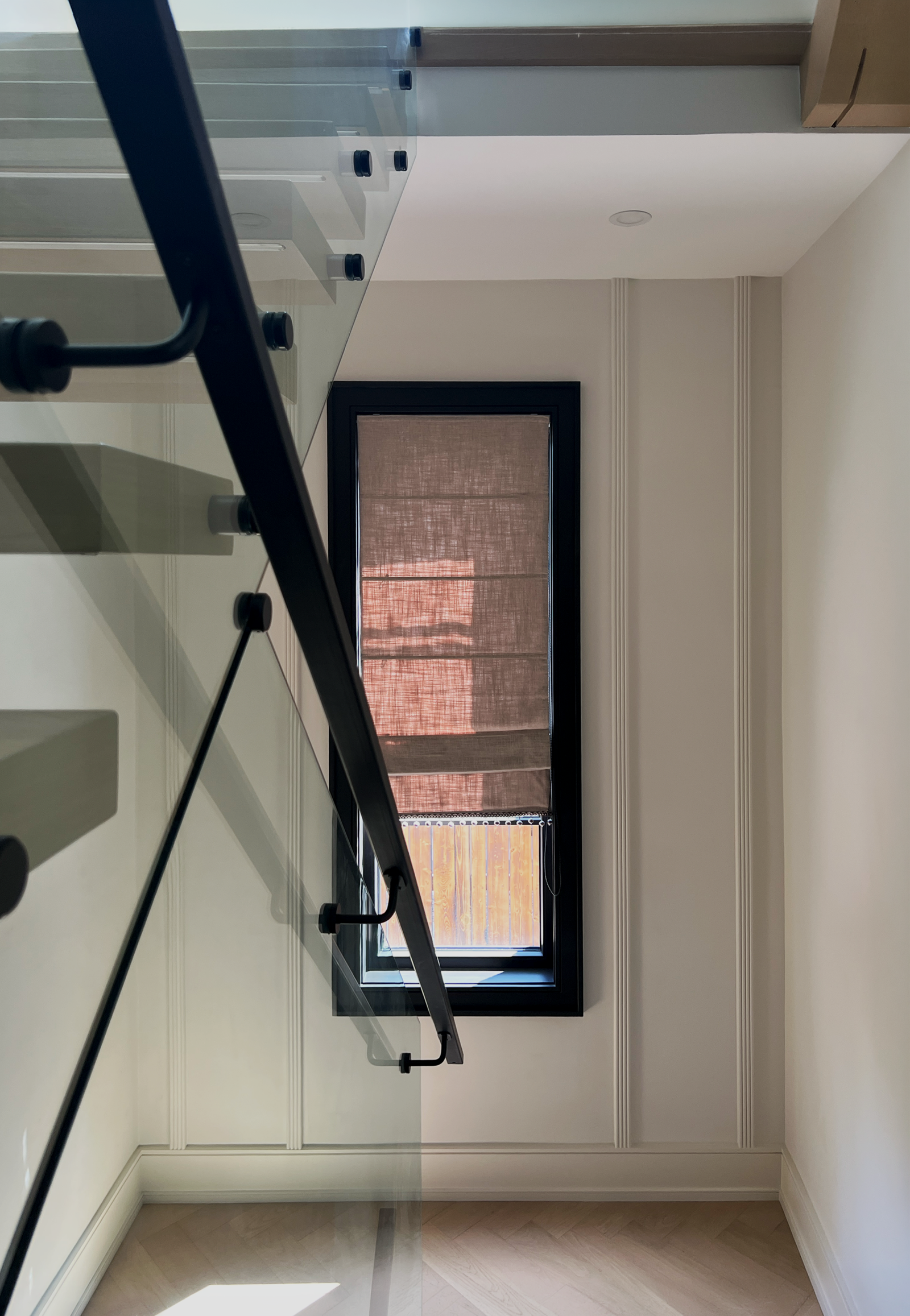 Decorative fabric Roman shades in a styled Toronto room, soft folds coordinated with the d&eacute;cor