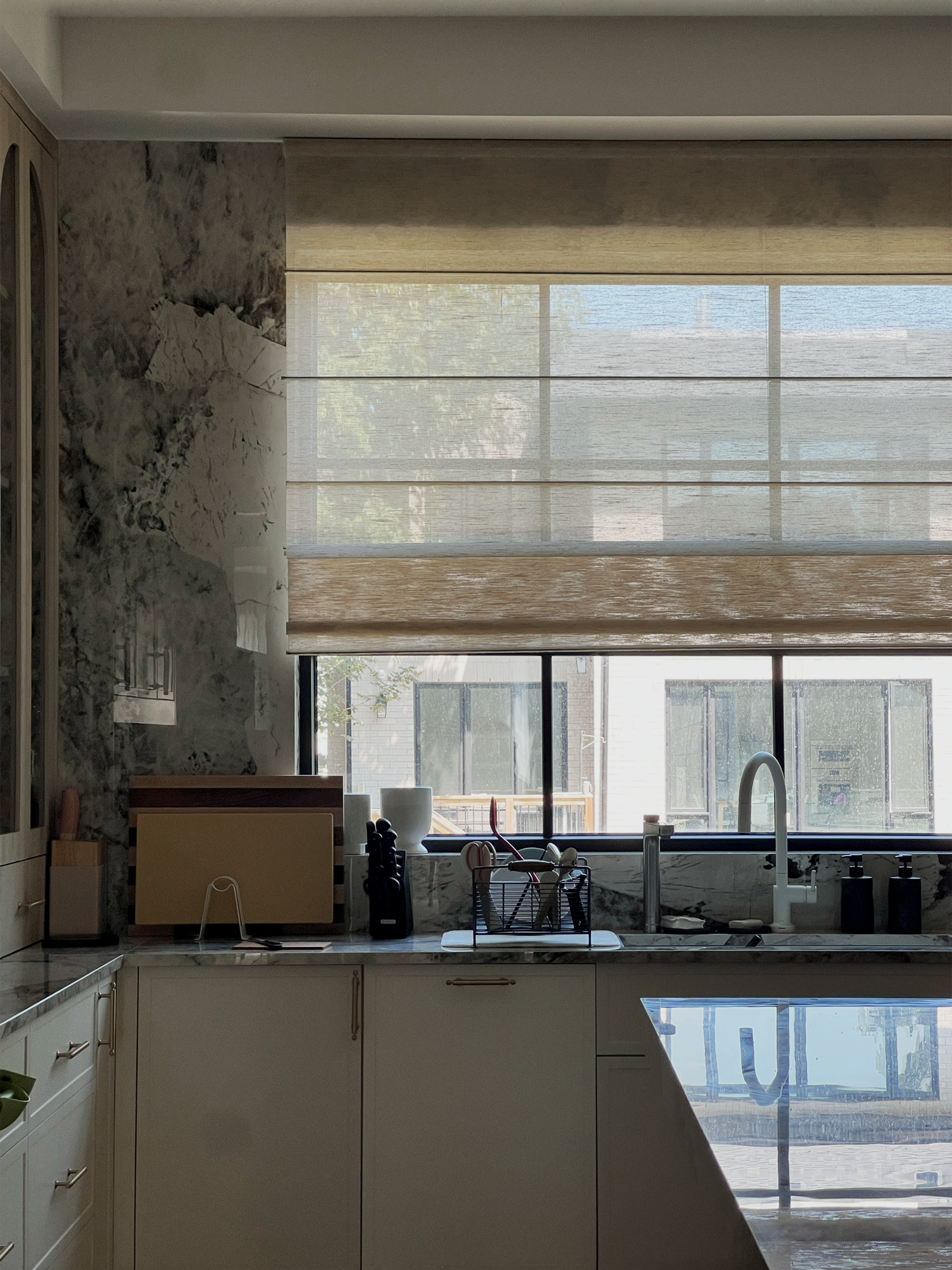 Natural bamboo Roman shades in a Toronto kitchen, warm woven texture filtering daylight