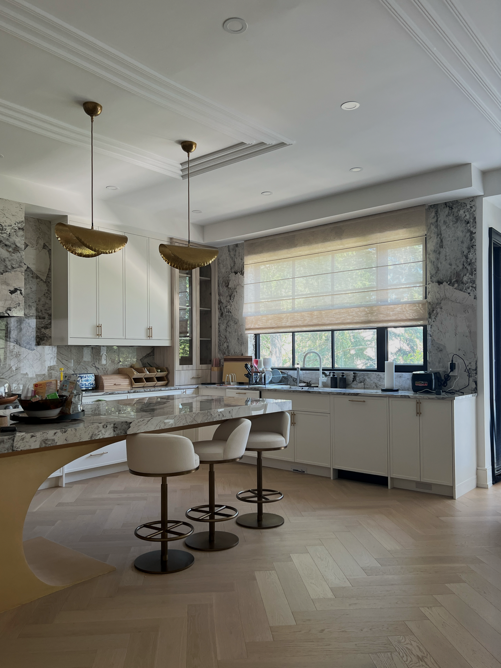 Custom Roman shades in a bright Toronto living room, soft tailored fabric folds