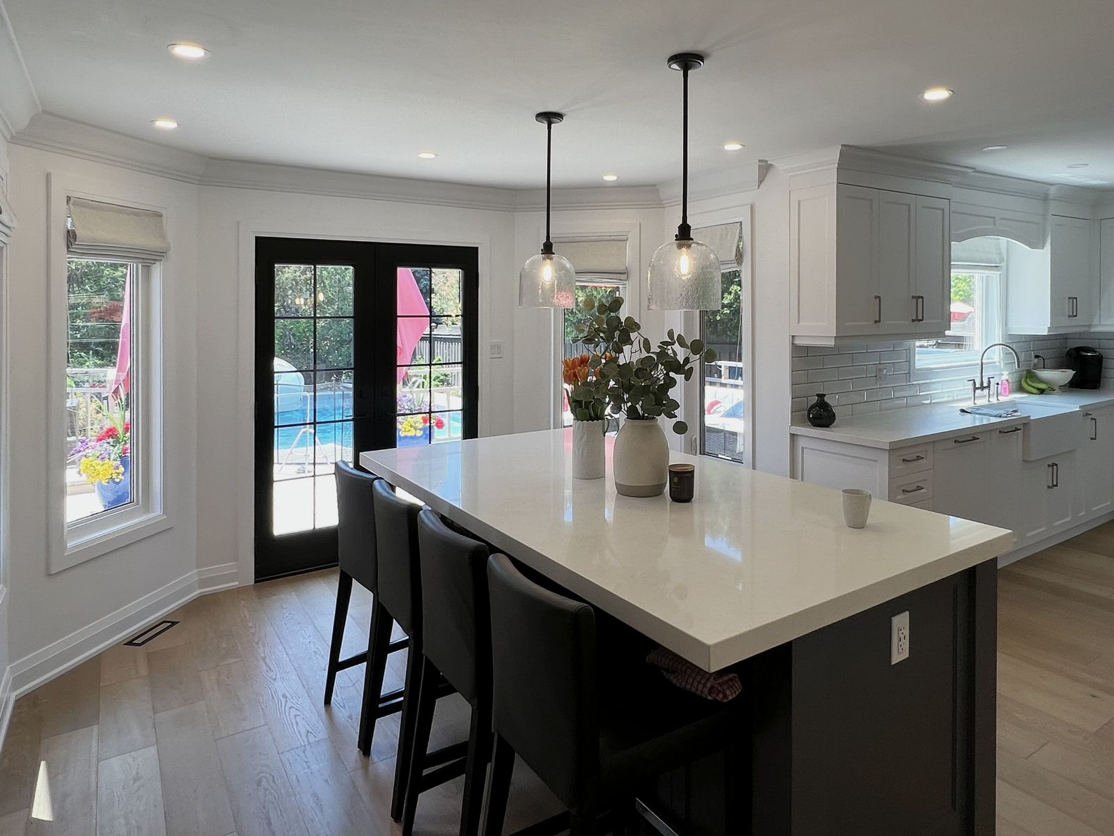 Roman shade in an open-concept Toronto kitchen beside floor-to-ceiling sheers