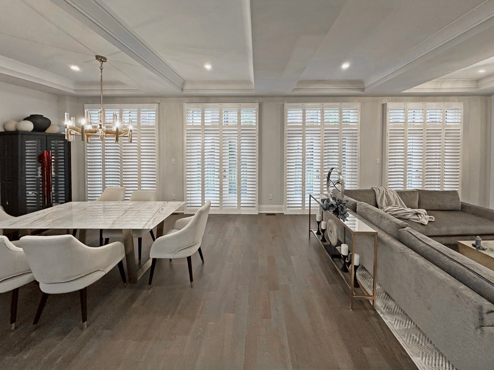 Custom bi-fold shutters folded back to one side of a doorway in a Toronto home