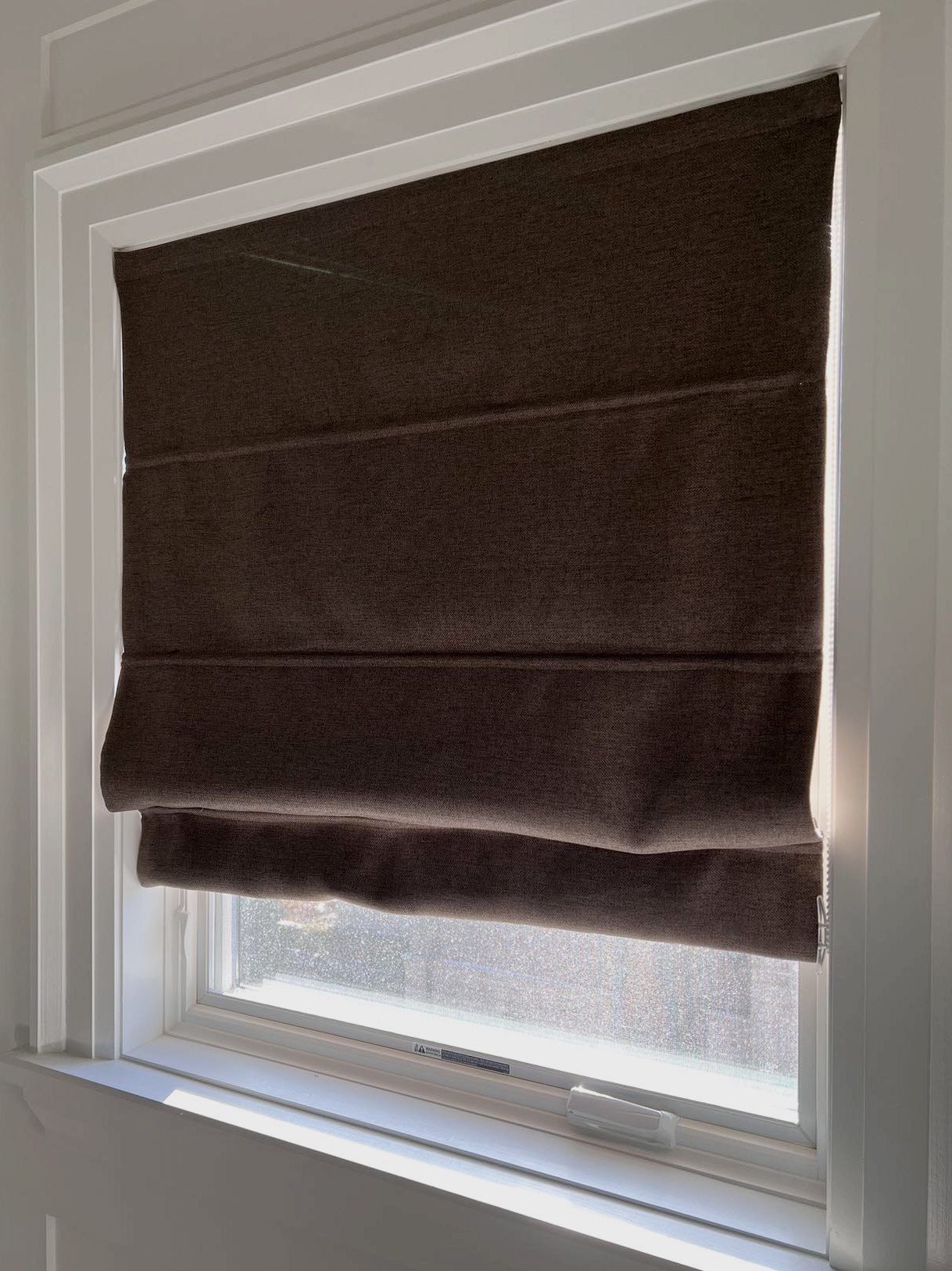 Fabric folds of a custom Roman shade up close in a Toronto home