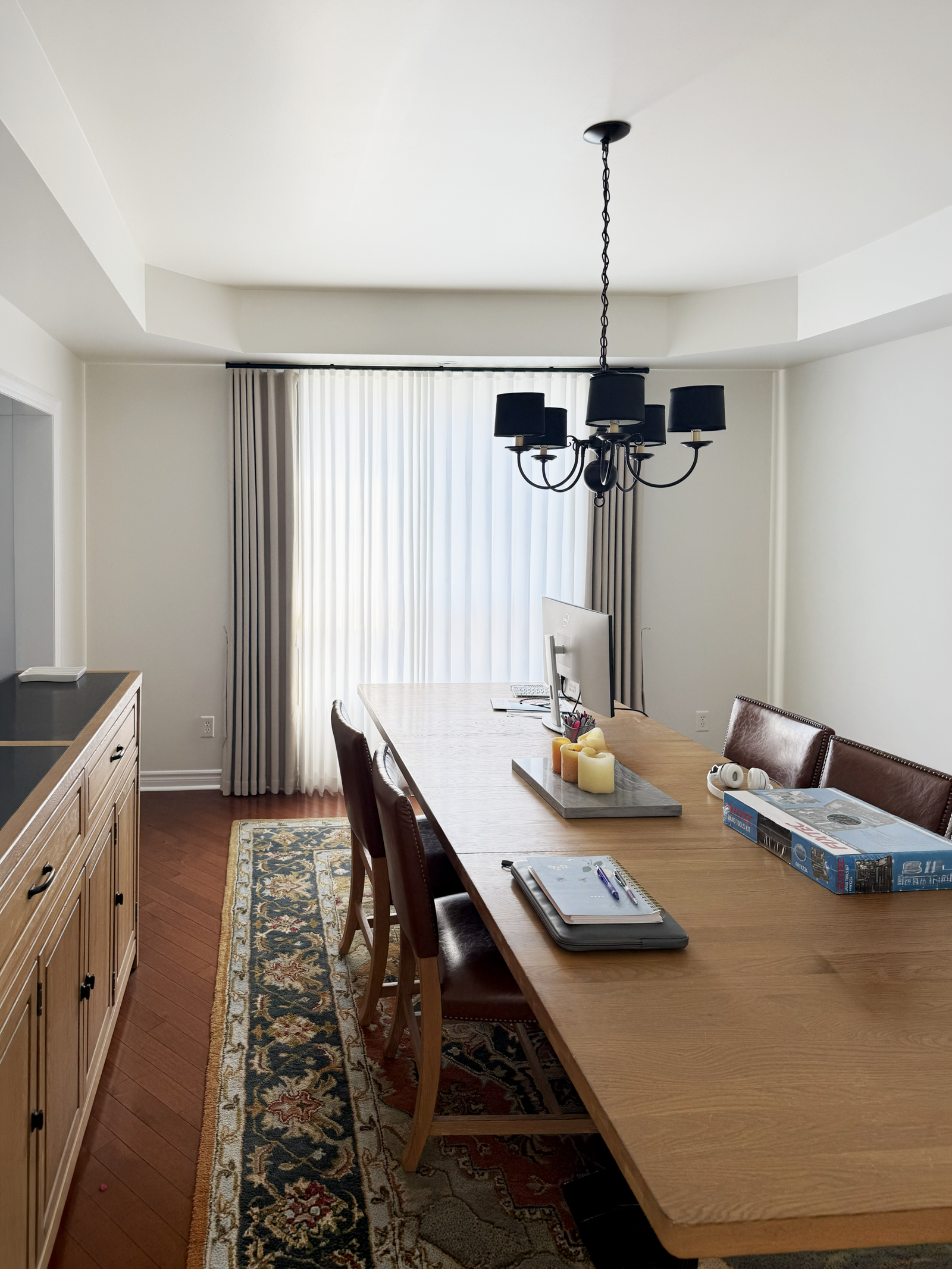 Decorative blackout curtains with a single sheer layer in a home office