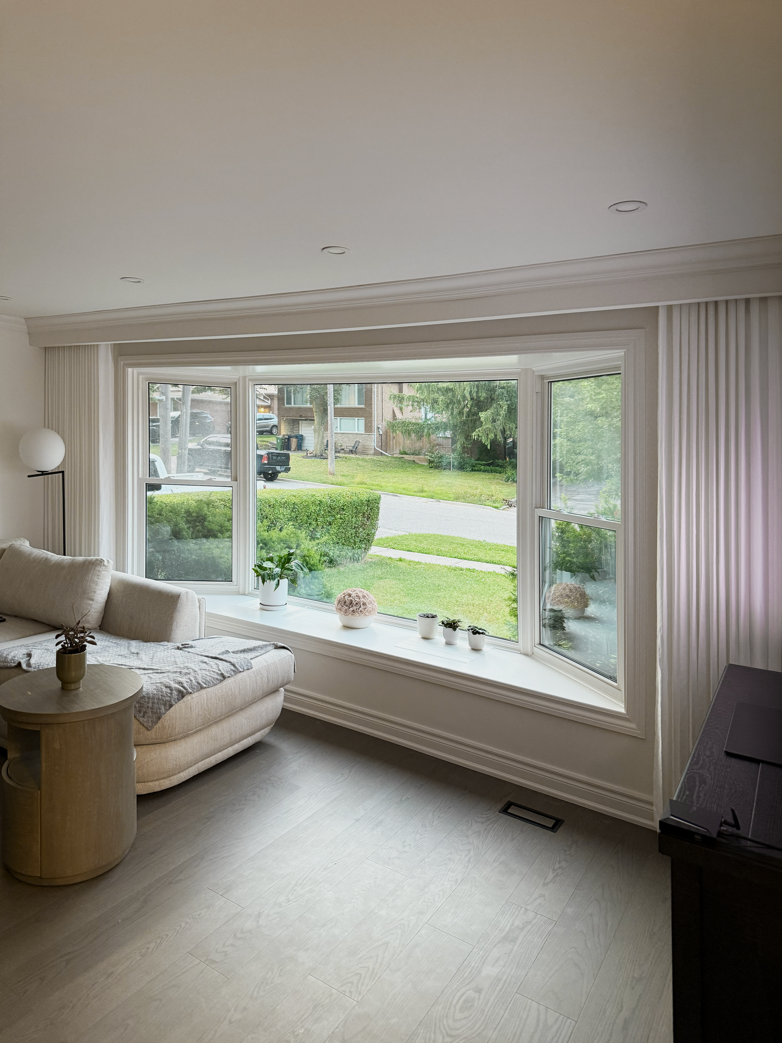 Custom sheer shades filtering soft light across a bright living area