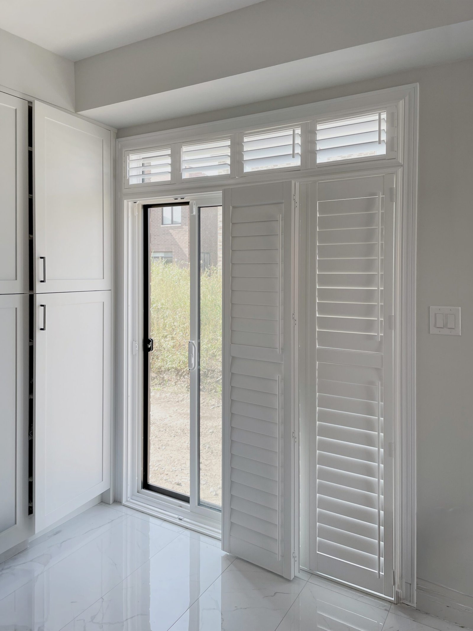 Bi-fold shutters framing a bright interior opening in Toronto