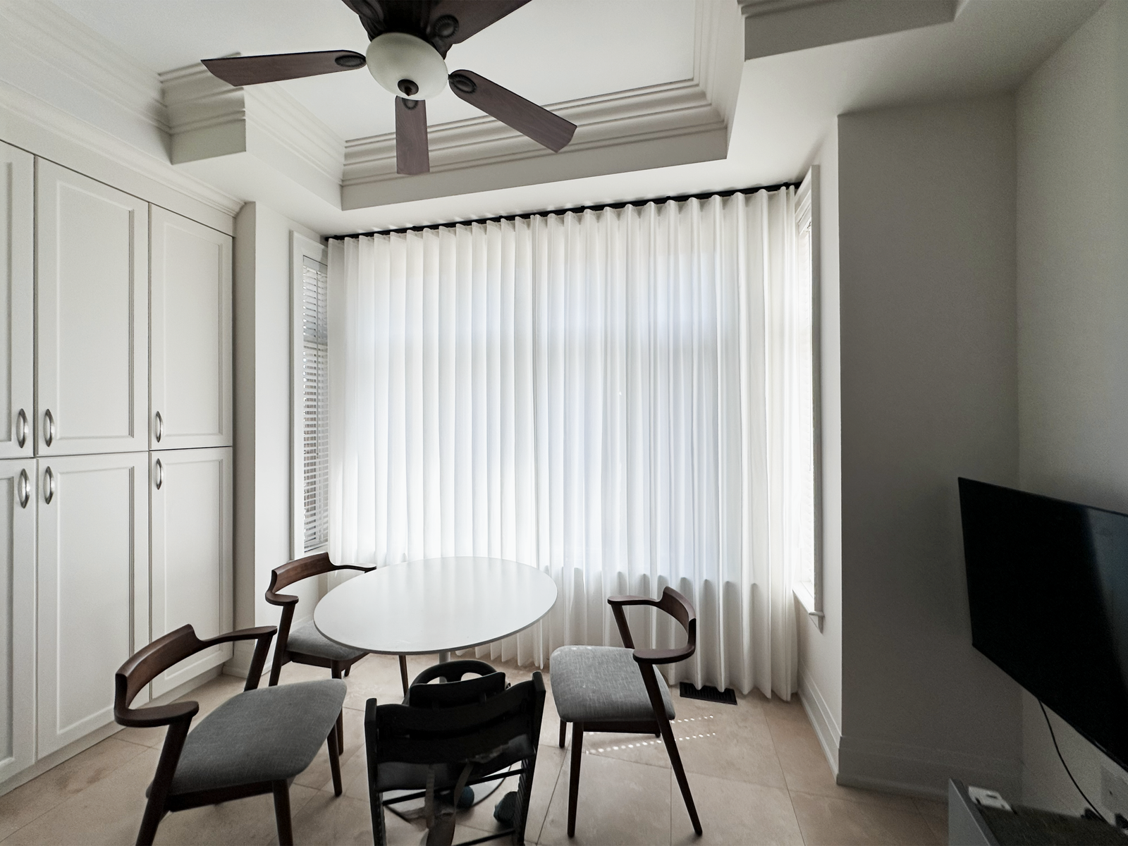 Custom window treatments installed in a bright Burlington home by Starlight Shutter