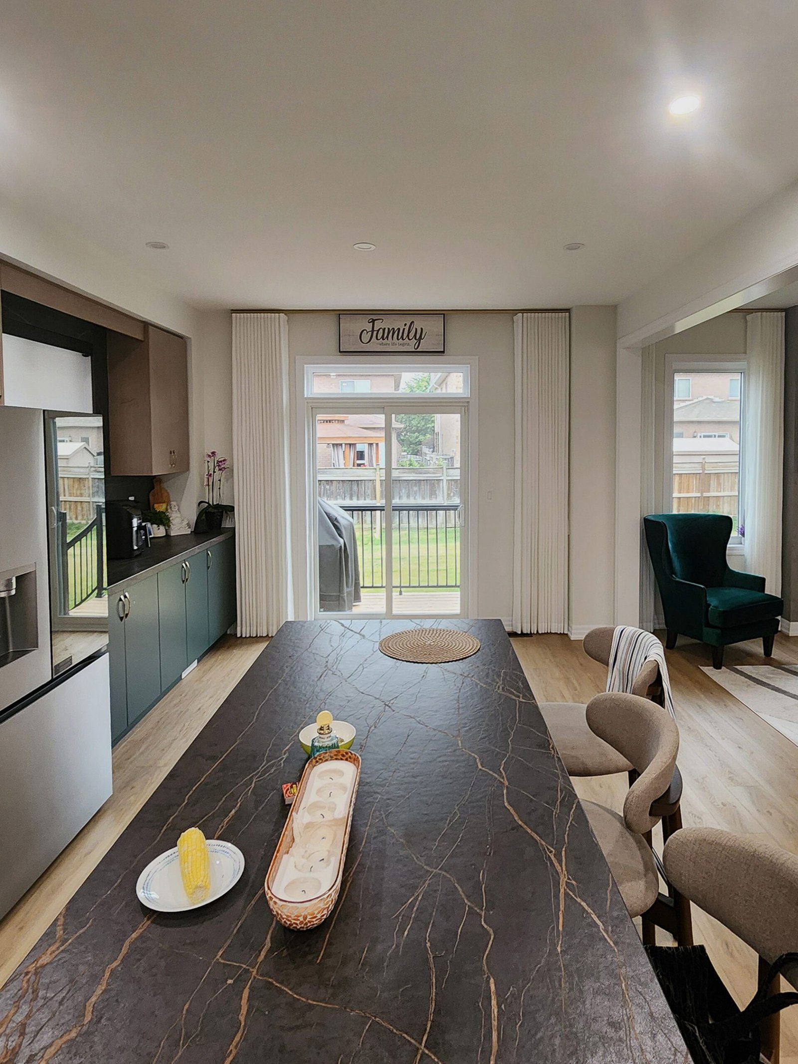 Custom sheer curtains framing an open-concept kitchen and dining area