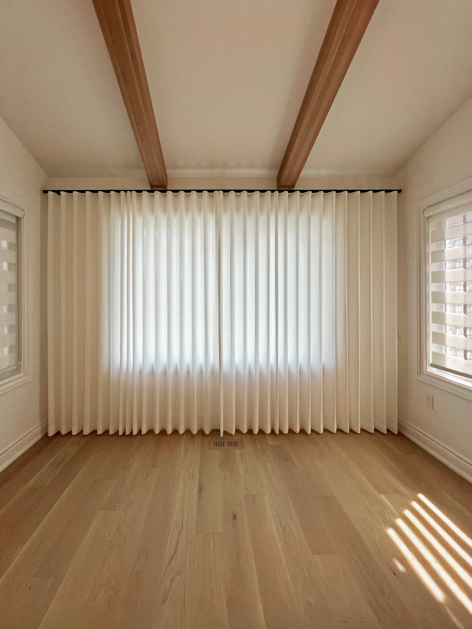 Ripplefold sheer curtains and zebra blinds in a Stouffville sun room
