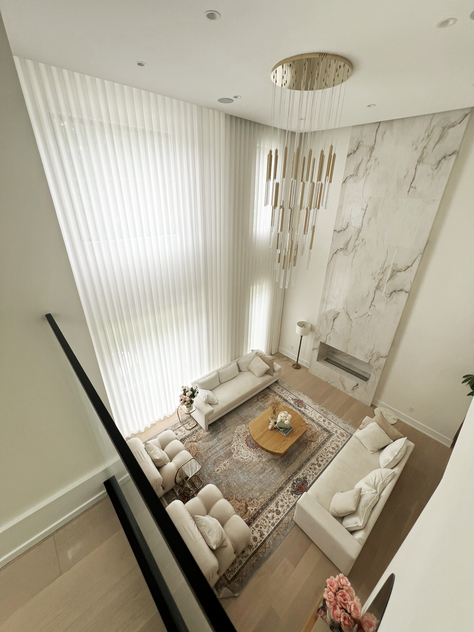 Sheer curtains on a tall two-storey window in a Mississauga home by Starlight Shutter