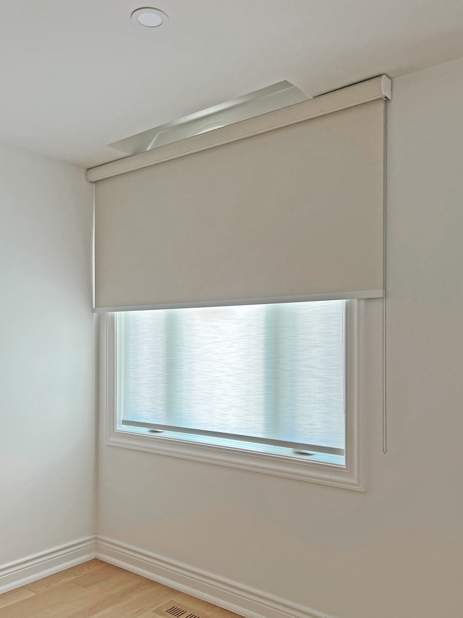 Dual roller blinds in a Stouffville bedroom
