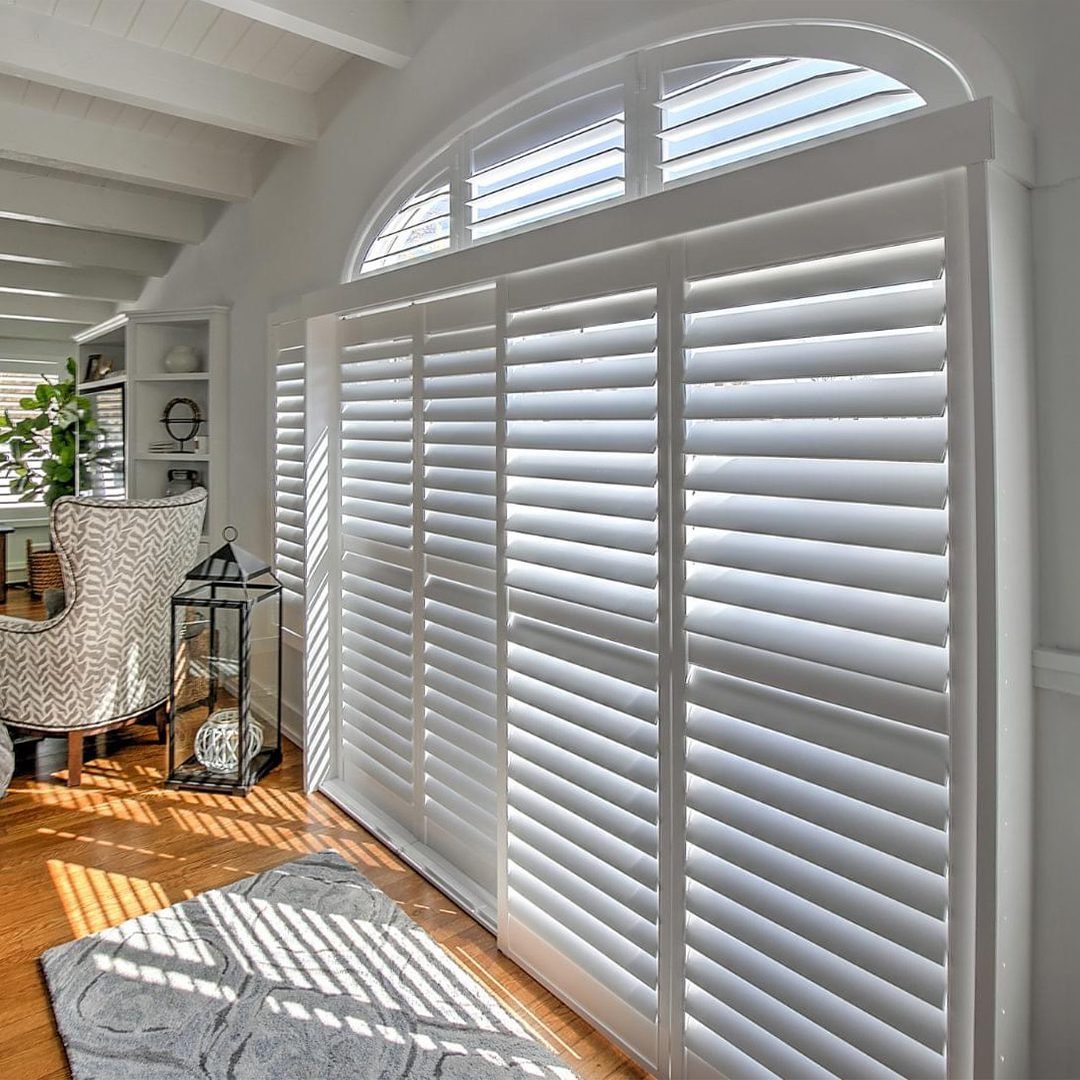 White custom sliding bypass shutters fitted across a wide opening in a Greater Toronto Area home