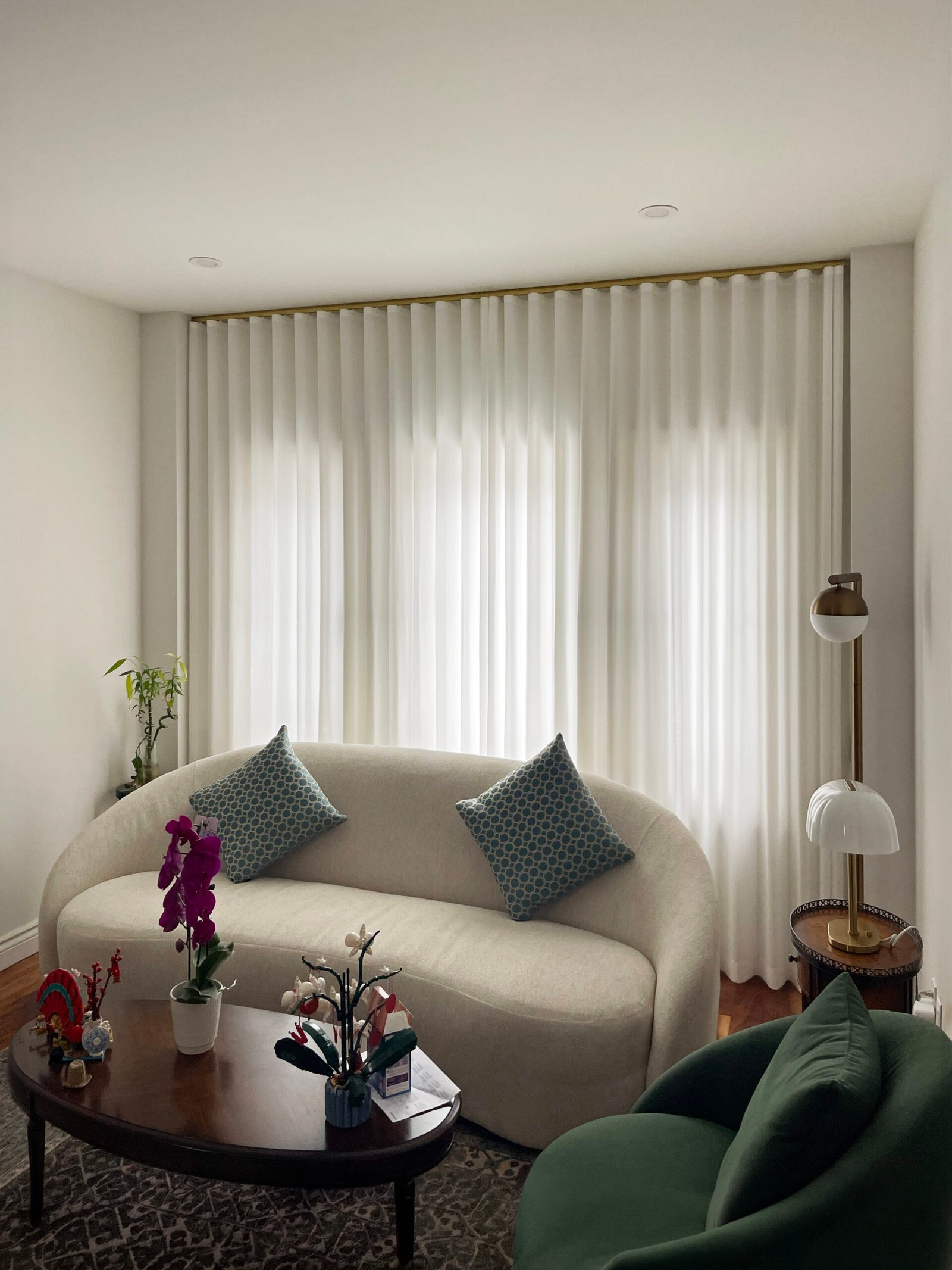 Sheer curtains running the full width of an Aurora living room by Starlight Shutter