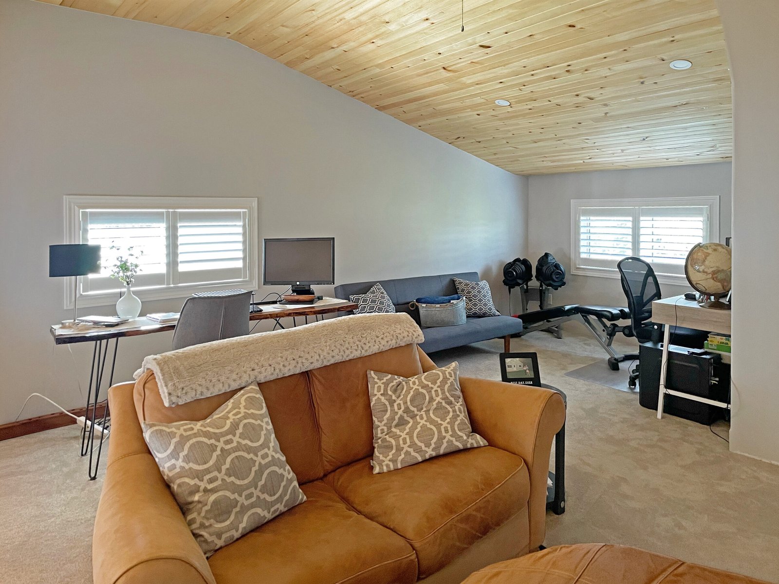 Wood shutters and transom windows in a Toronto attic sitting room