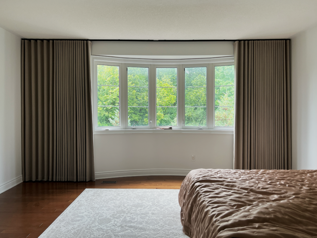 a bedroom bay window with blackout curtain in milton
