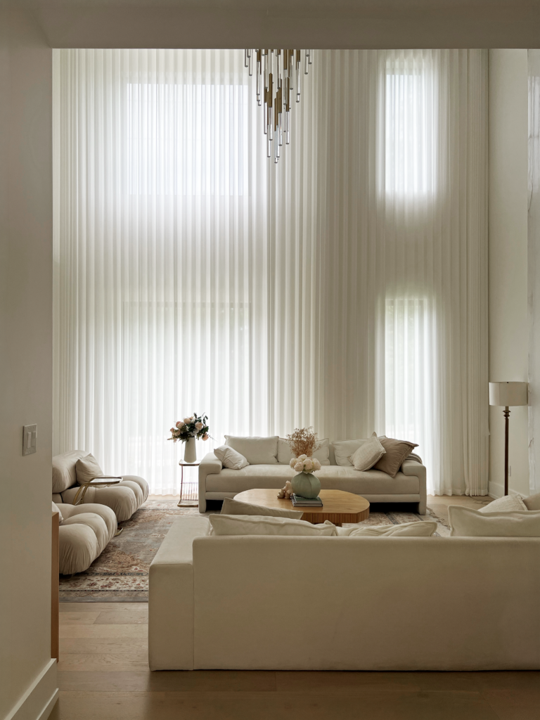 Floor to ceiling sheer drapery on a two storey living room window in a Mississauga home.