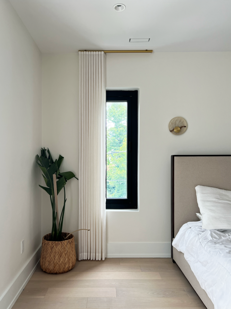 Linen ripplefold drapery on a narrow bedroom window.