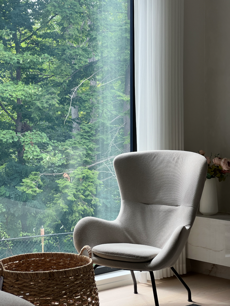 Sheer drapery beside a reading chair in a Mississauga family room.